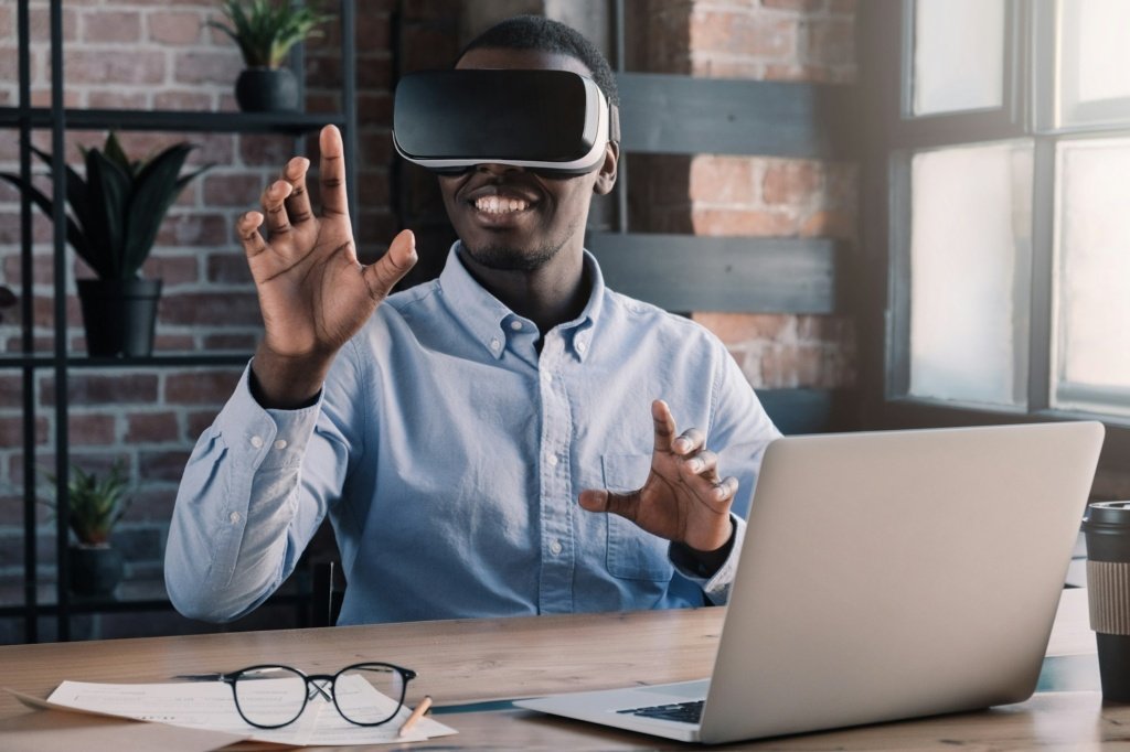 Young african american IT-professional using augmented VR in modern loft office